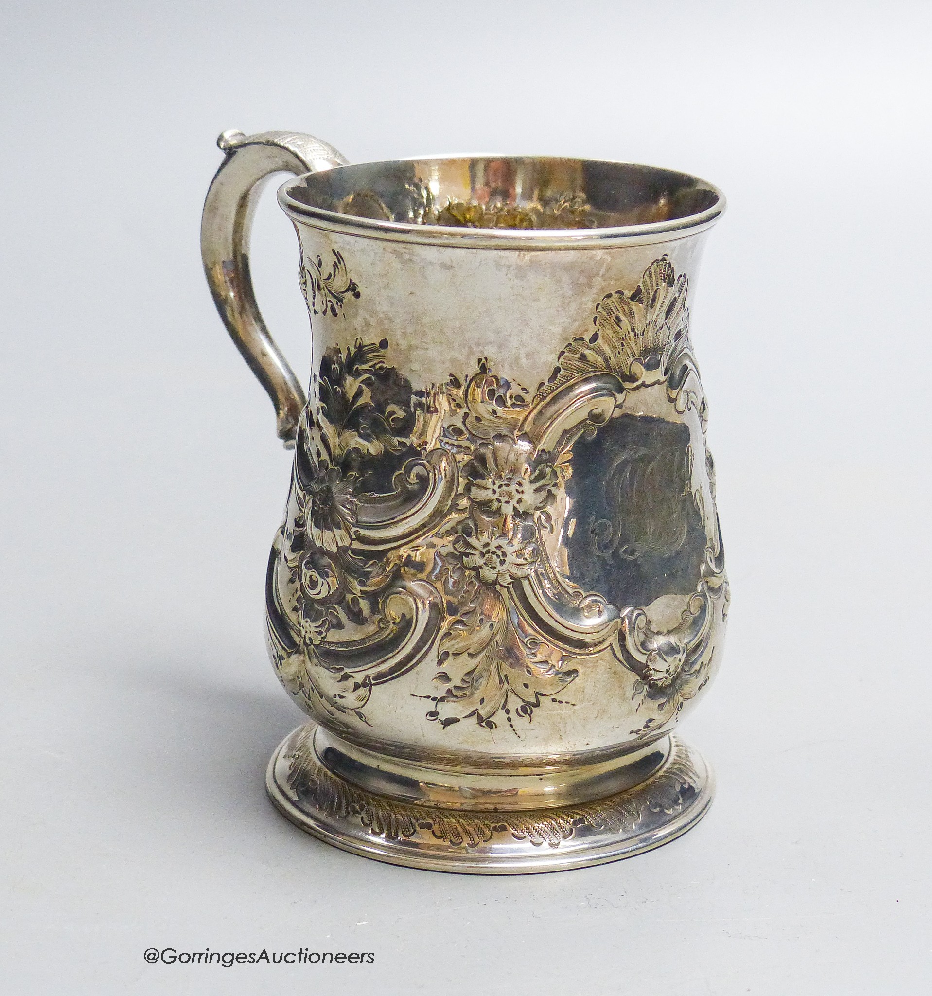 A George II provincial silver baluster mug, with later embossed decoration, James Kirkup, Newcastle, 1751, 10cm, 5.5oz.
